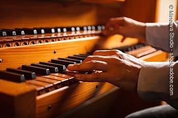 Detail of a man playing a church organ