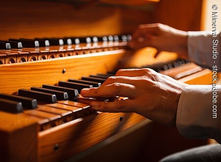 Detail of a man playing a church organ